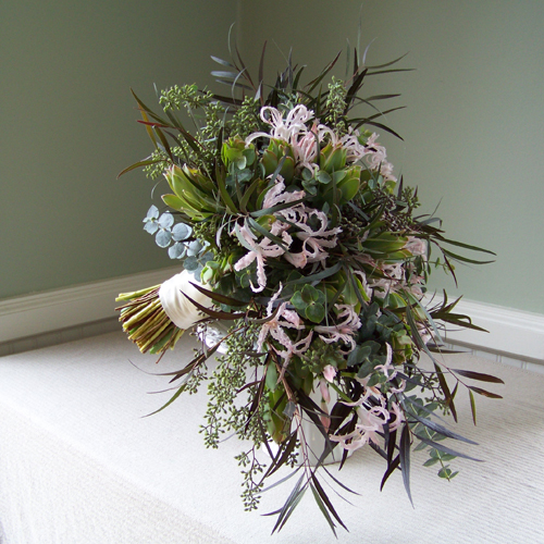hand-tied cascade with blush nerine lilies, agonis, baby blue eucalyptus, seeded eucalyptus, and green leucadendron