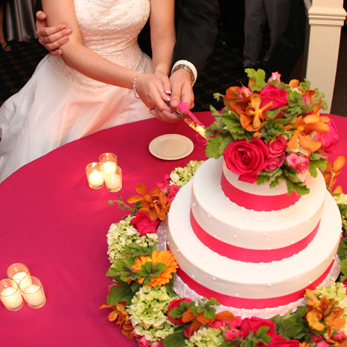 wedding cake encircled Kiko roses, Twinkle Bride spray roses, green hydrangea, orange vanda orchids and Fabio gerberas