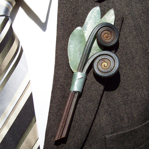 boutonniere made from silver tree and uluhe fern curls