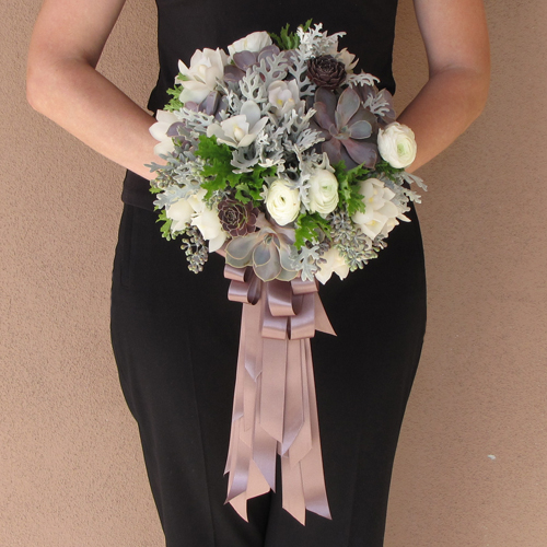Hand-tied bridal bouquet with purple Aeonium, Echeveria hybrid 'Perle von Nurnberg', dusty miller, seeded eucalyptus, white mini cymbidium orchids, white ranunculus and scented geranium, with cascading loops of satin ribbon